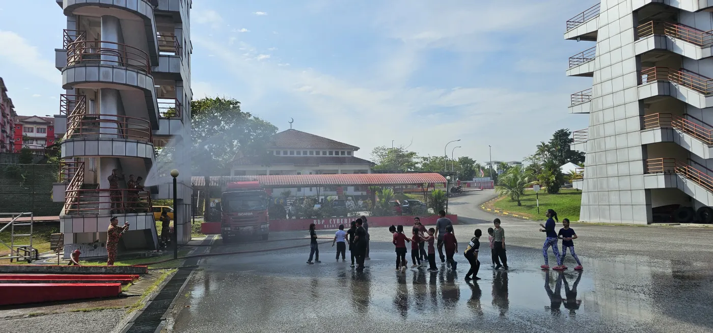 Children playing with water during the Junior Firefighters session