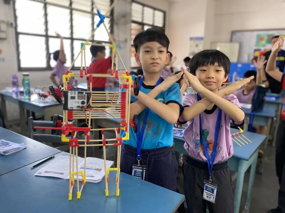 Boys posing with a tall electric vehicle designed to look like a robot